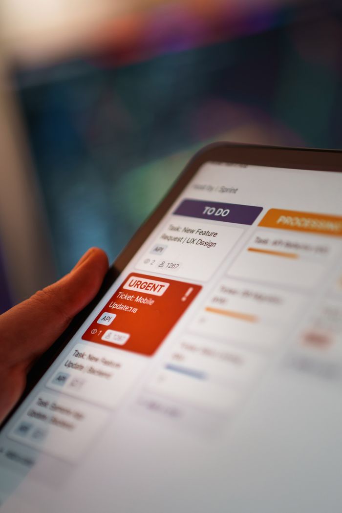 Services Close-up of a digital kanban board on a tablet for task management in a modern office